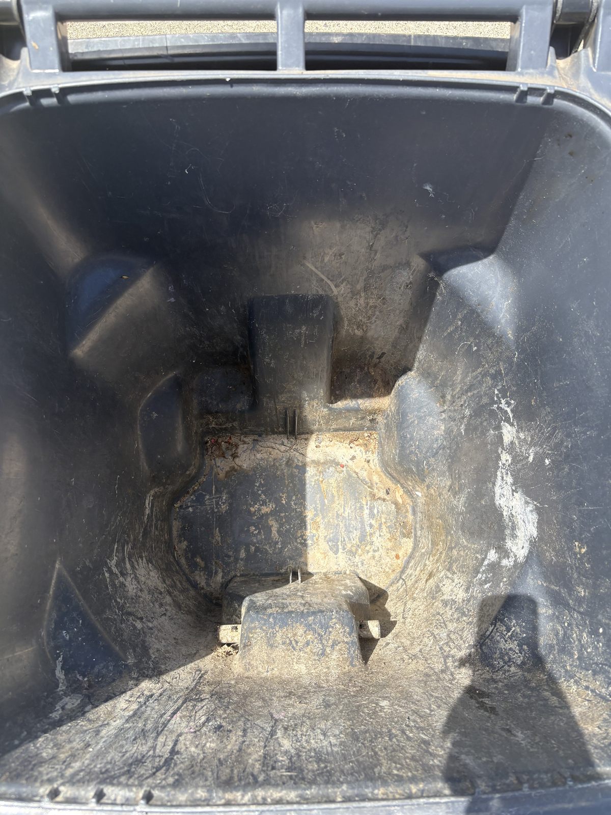 Dirty trash bin interior before a BinBoys cleaning